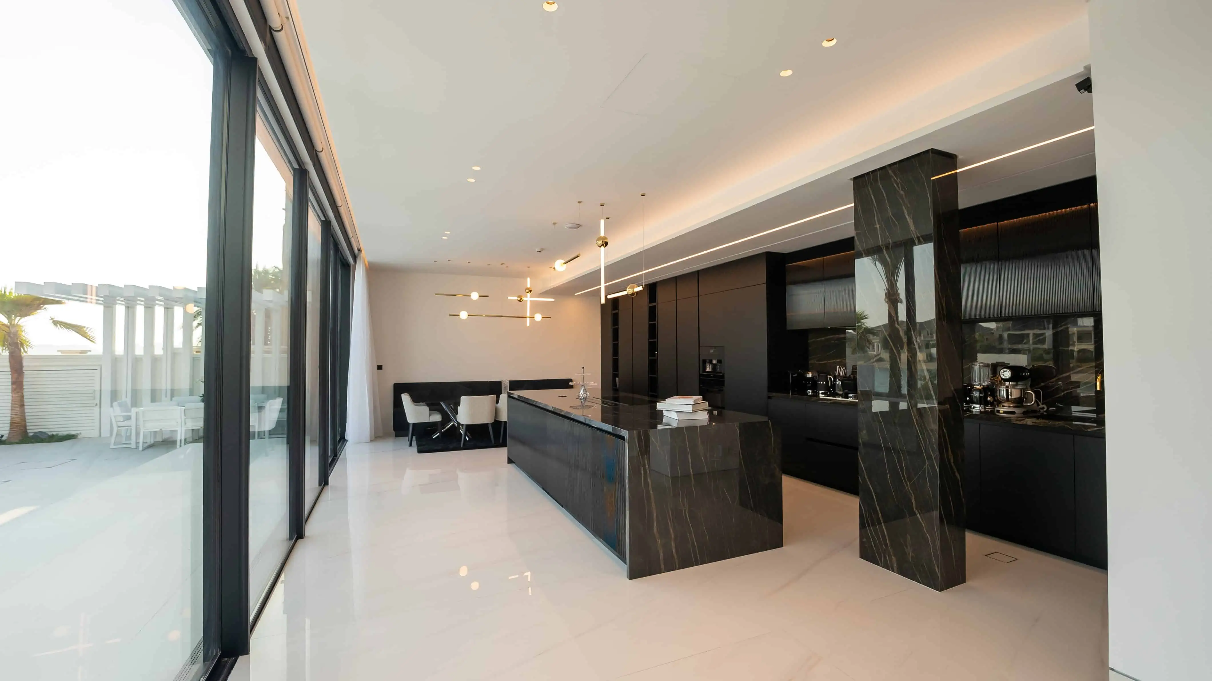 A sleek kitchen with black cabinets and glass doors, perfect for a contemporary home.