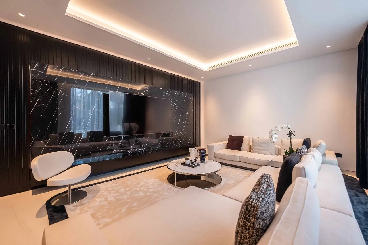 A stylish living room with sleek black walls and elegant white furniture. A perfect blend of modernity and sophistication.