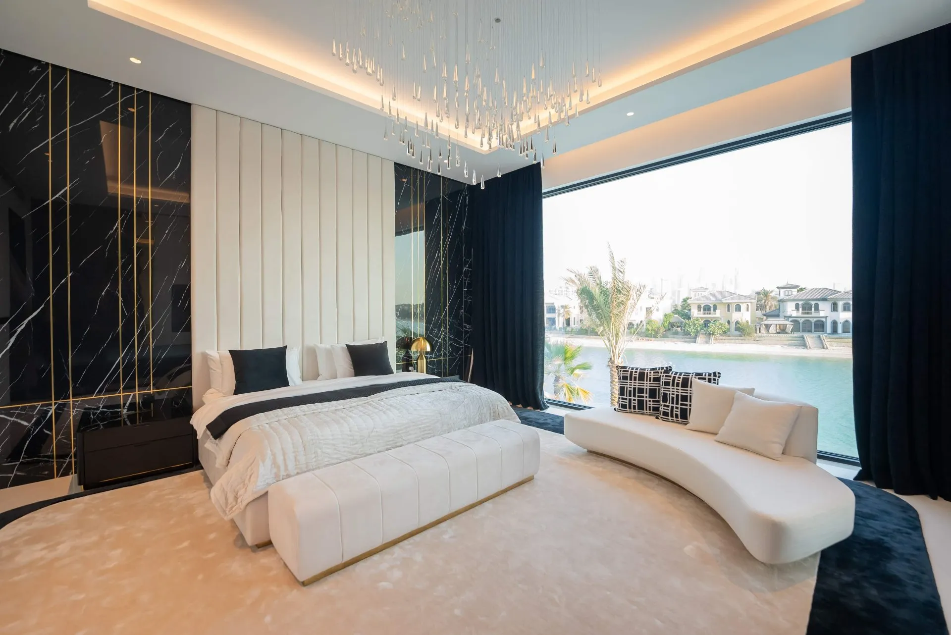 A serene modern bedroom with a spacious bed and a breathtaking water view.