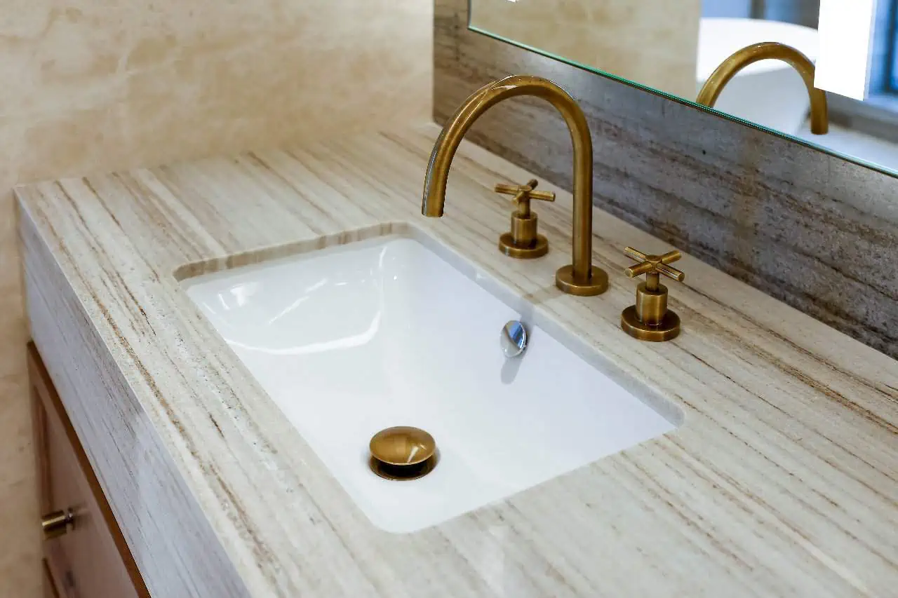 a sink with gold faucets