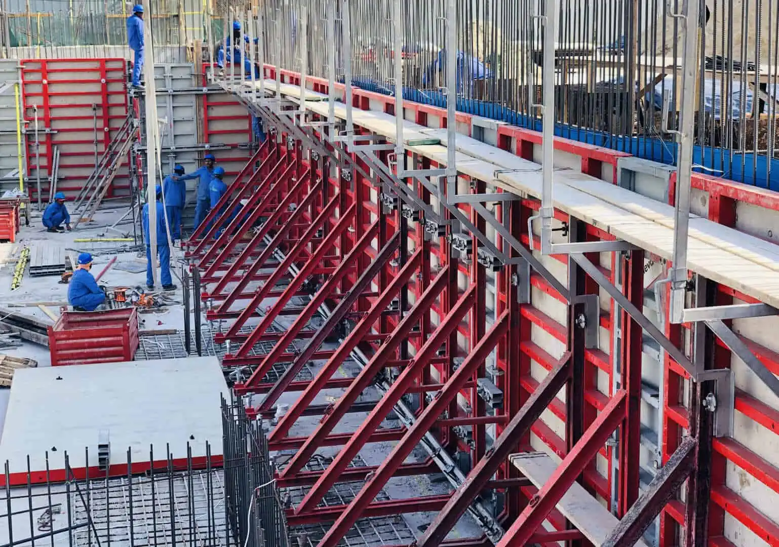 An incredible structure being built on a construction site, adorned with red and white colors.