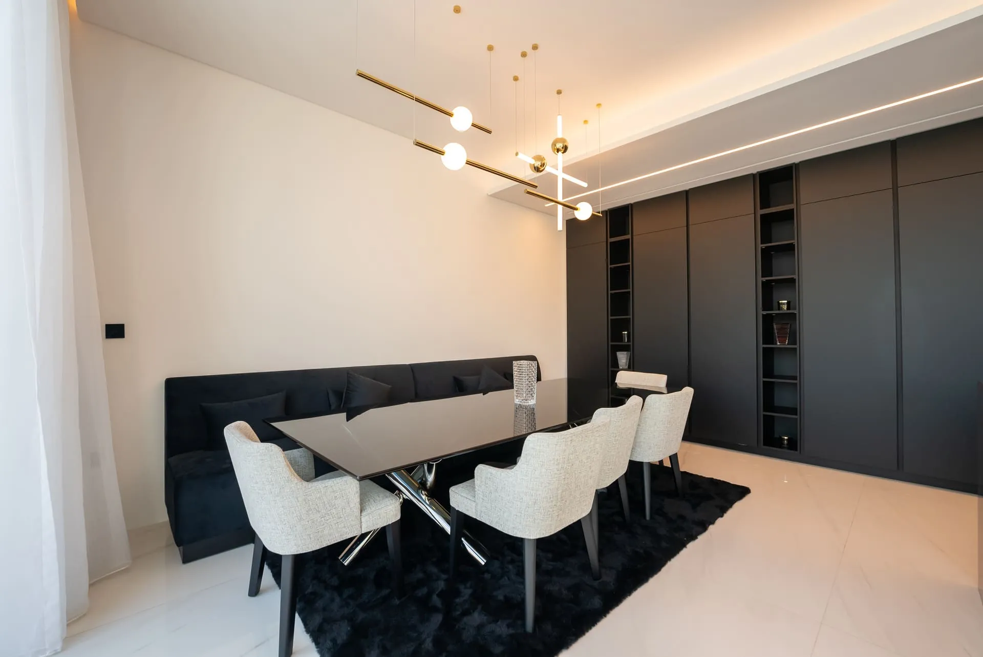A stylish dining room with sleek black and white furniture, creating a modern and sophisticated ambiance.