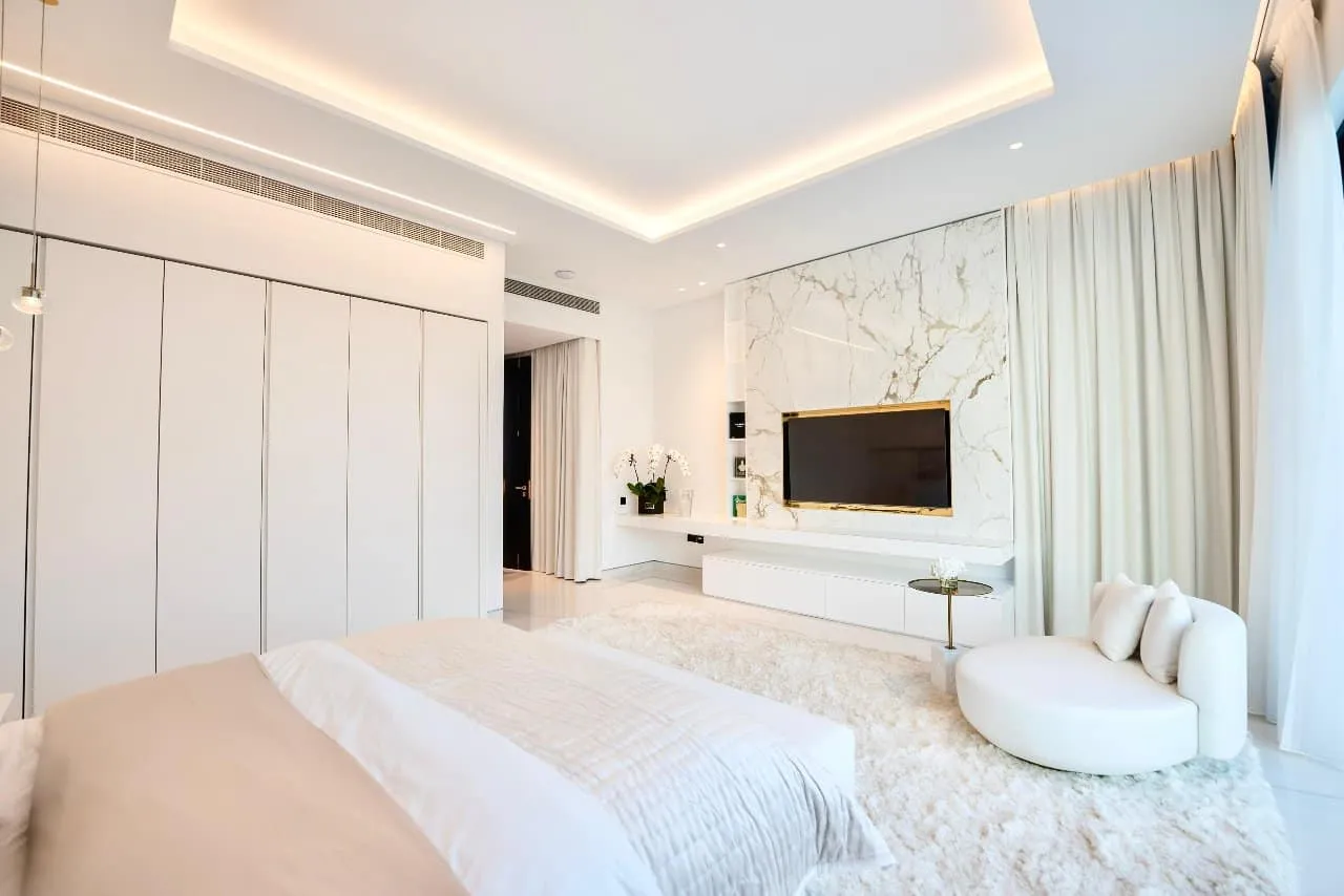 master bedroom with a white bed and a white rug