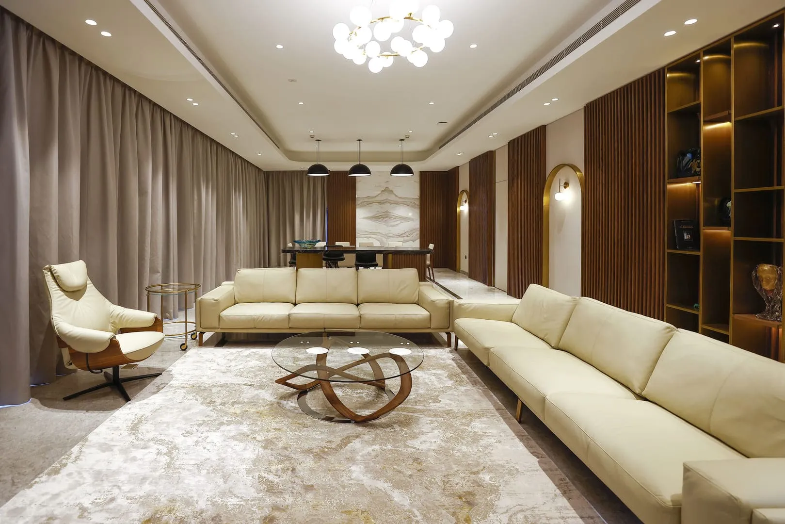 A cozy living room with a spacious sofa and a stylish coffee table. Perfect for relaxation and gatherings.
