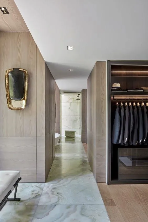 A sleek hallway with a closet and a bench, perfect for adding style and functionality to your home decor.