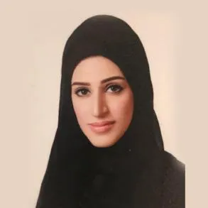 A woman wearing a black hijab, radiating elegance and grace.