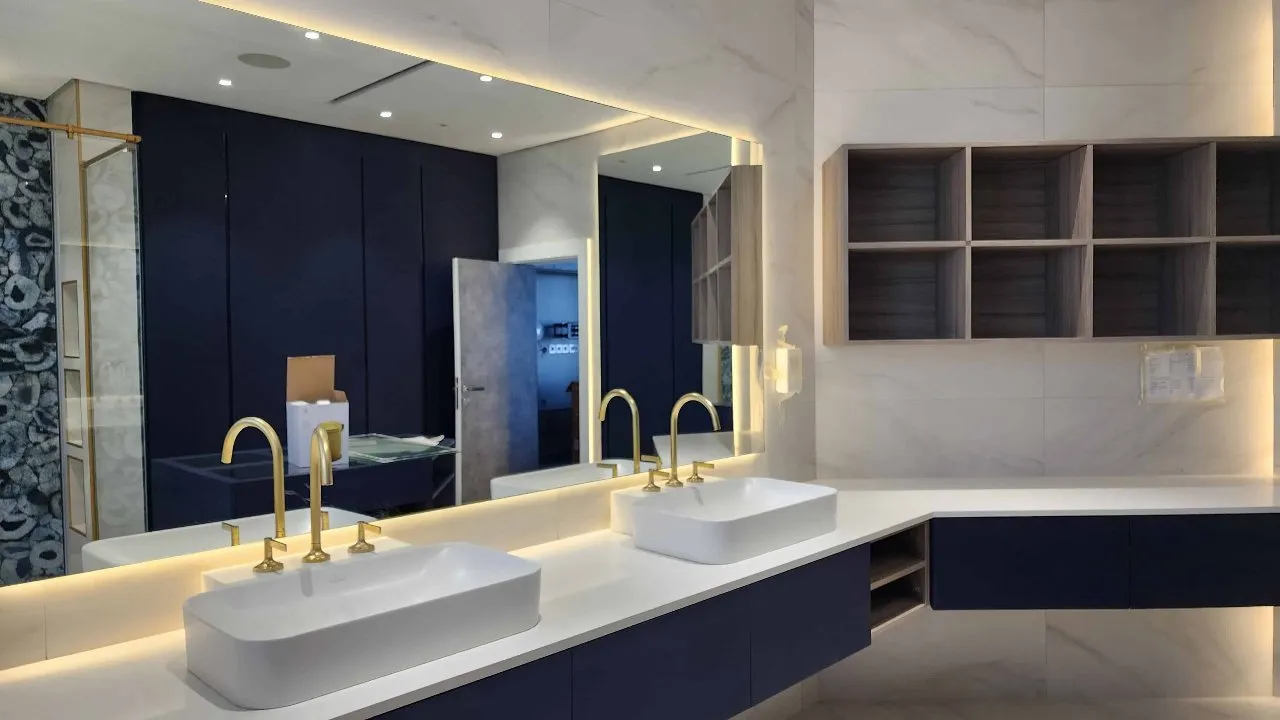 A modern bathroom with elegant blue and gold fixtures, creating a luxurious and stylish ambiance.